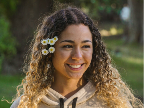 Teen with straight teeth and flowers in her hair